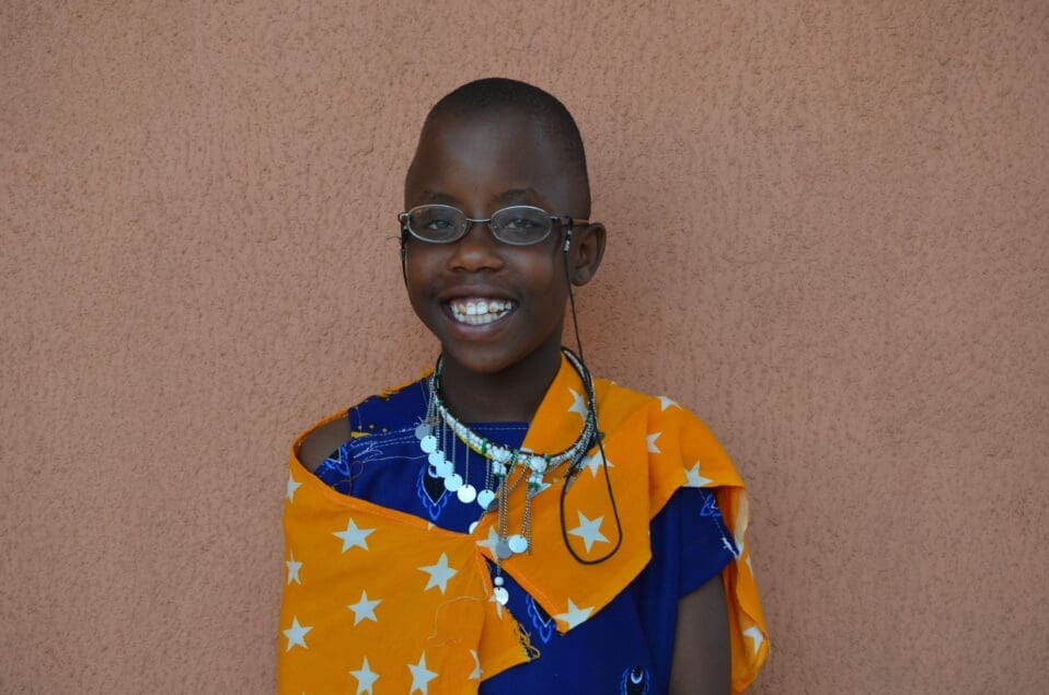 Bahati smiling wearing traditional maasai apparel