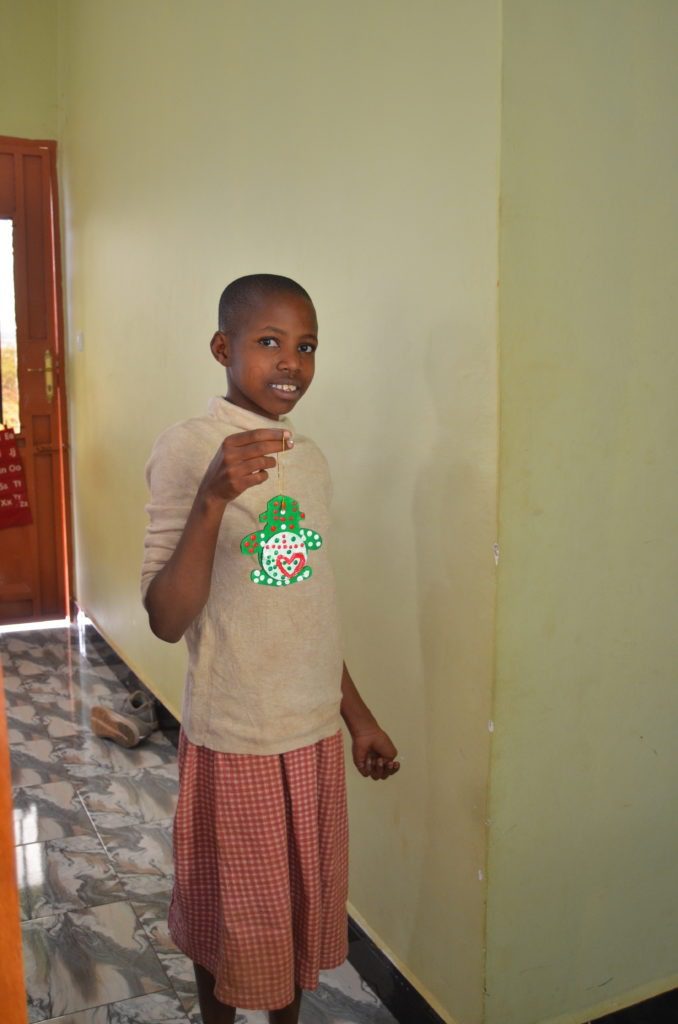 Lenoi with the ornament she painted for her sponsor.