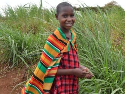 blog stories of empowerment - Young Maasai girl wearing a traditional shuka at MGRC ecoFarm
