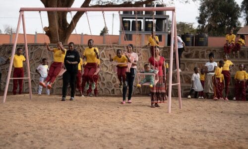 girls playing on swingset