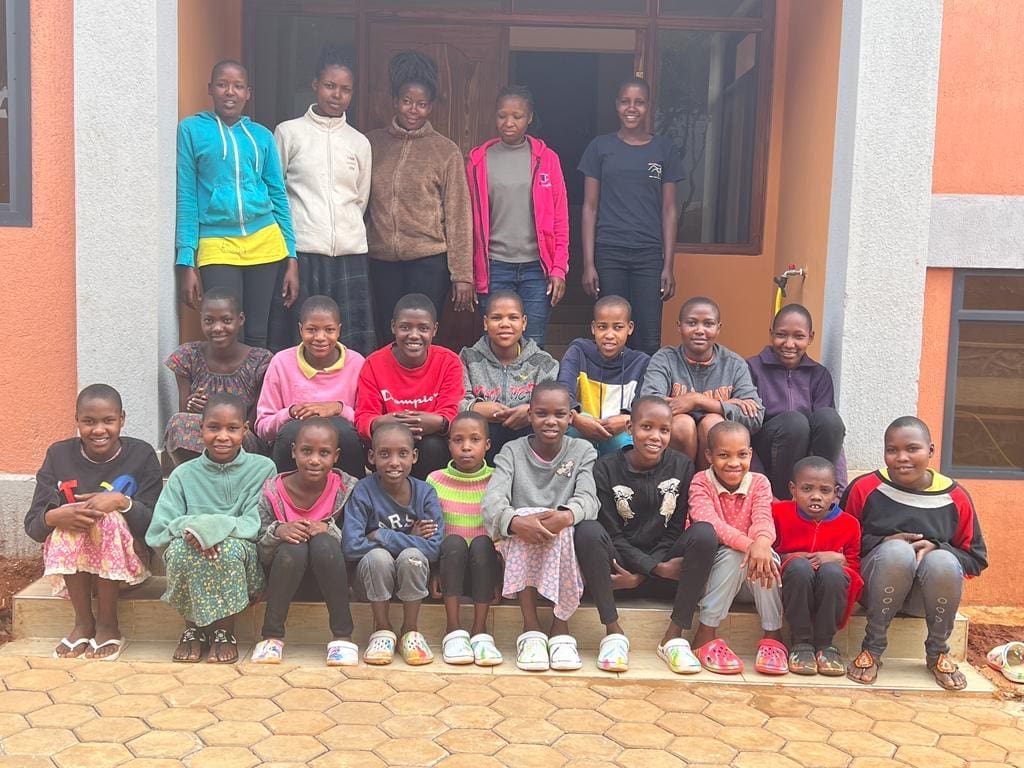 our older girls sitting ourtide their new home with their house mothers