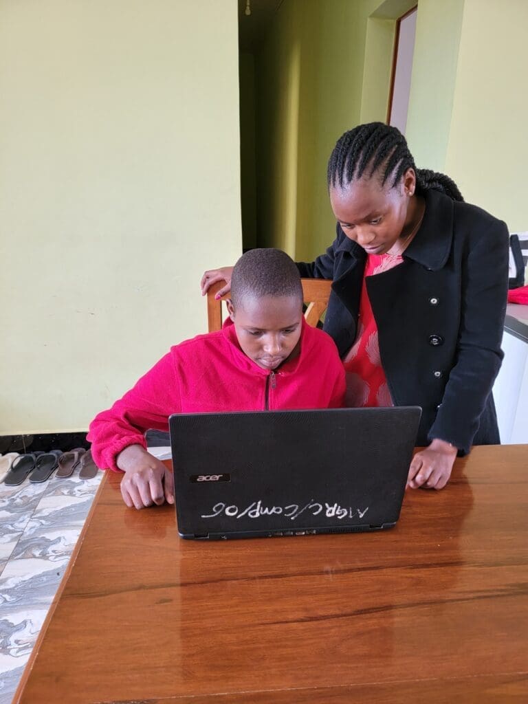teaching computer skills to maasai girl