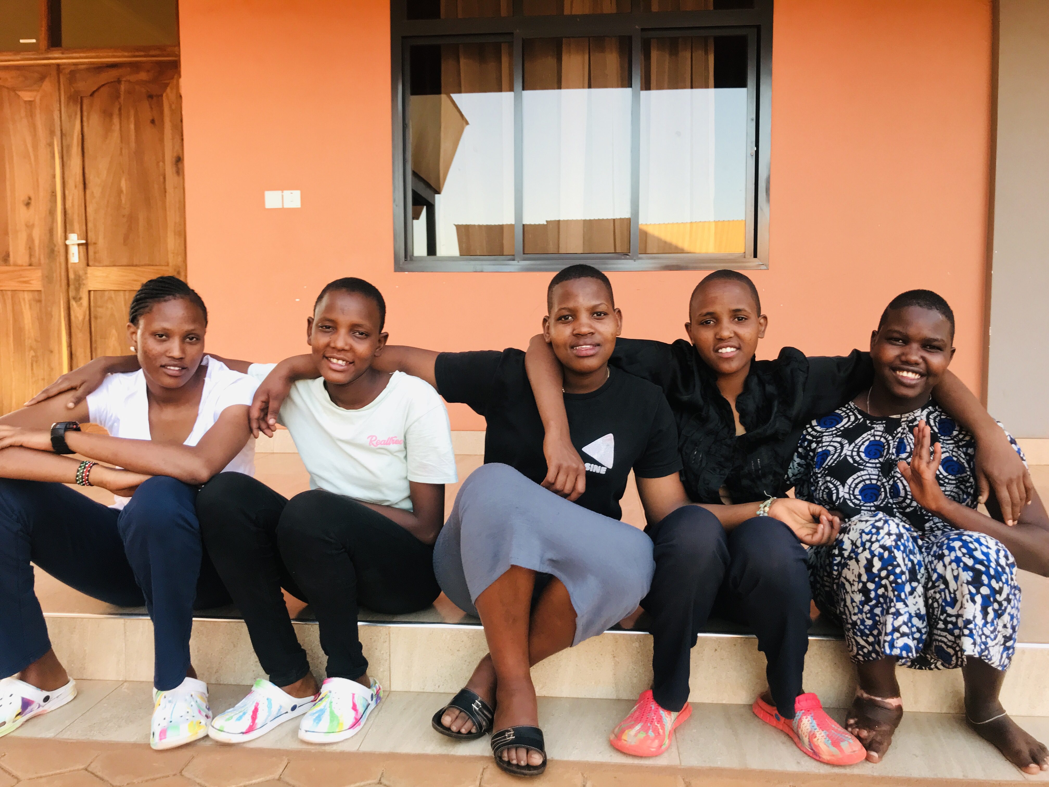 the older MGRC girls sitting in front of their ecoHome