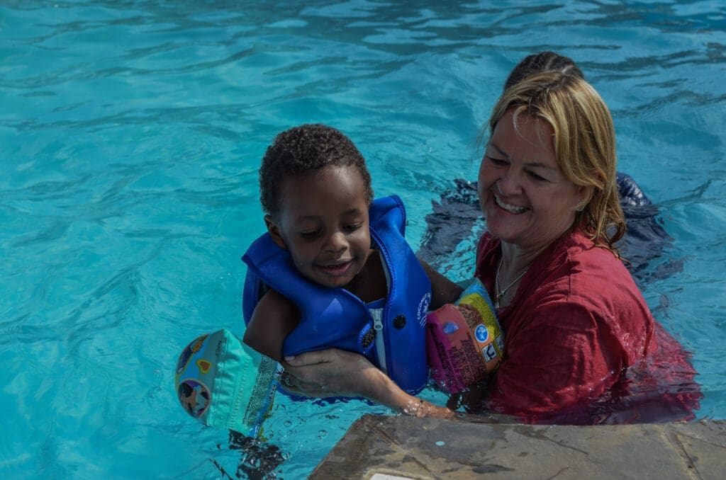A volunteer giving MGRC girls their first swimming lesson highlights Maasai girls transformation.