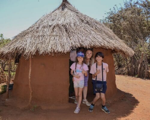 guests at the maasai culture center exploring a real life maasai boma
