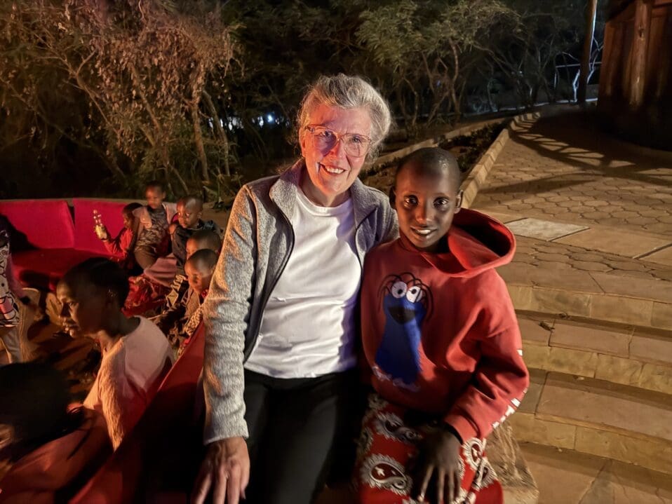 mgrc sponsor sitting with several maasai girls